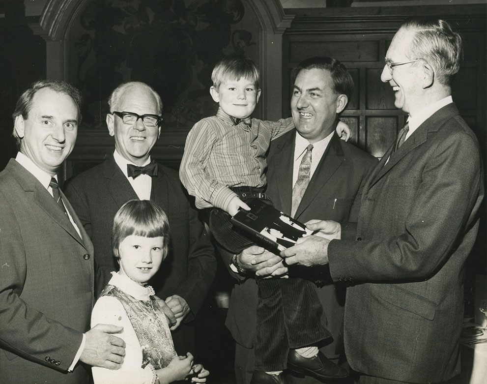 PS    This picture, taken at the CandL 50th Anniversary Dinner in 1971 held in the Merchant Taylors Hall, Aldwark, York shows from left to right – Ron Thompson (Pat Light’s son-in-law), Pat Light with Liese (Denys’ daughter and mother of Chloe, who designed the latest CandL logo), Denys Cussins holding son Paul (who now runs CandL) and Regge Cussins.